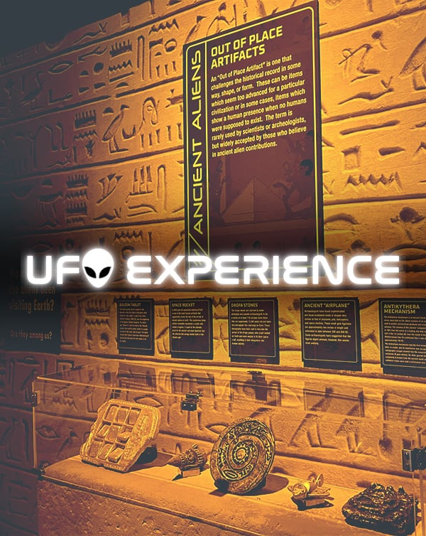 Display with fake mummified alien with sign that reads "Warning to all Explorers!"